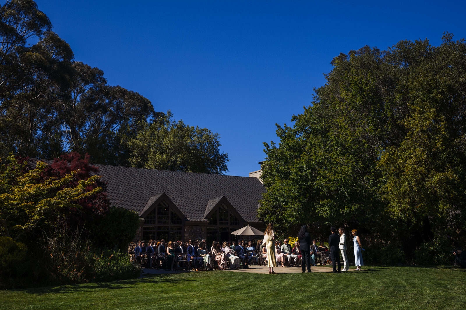 The Brazilian Room under a clear May sky as guests gather on the lawn