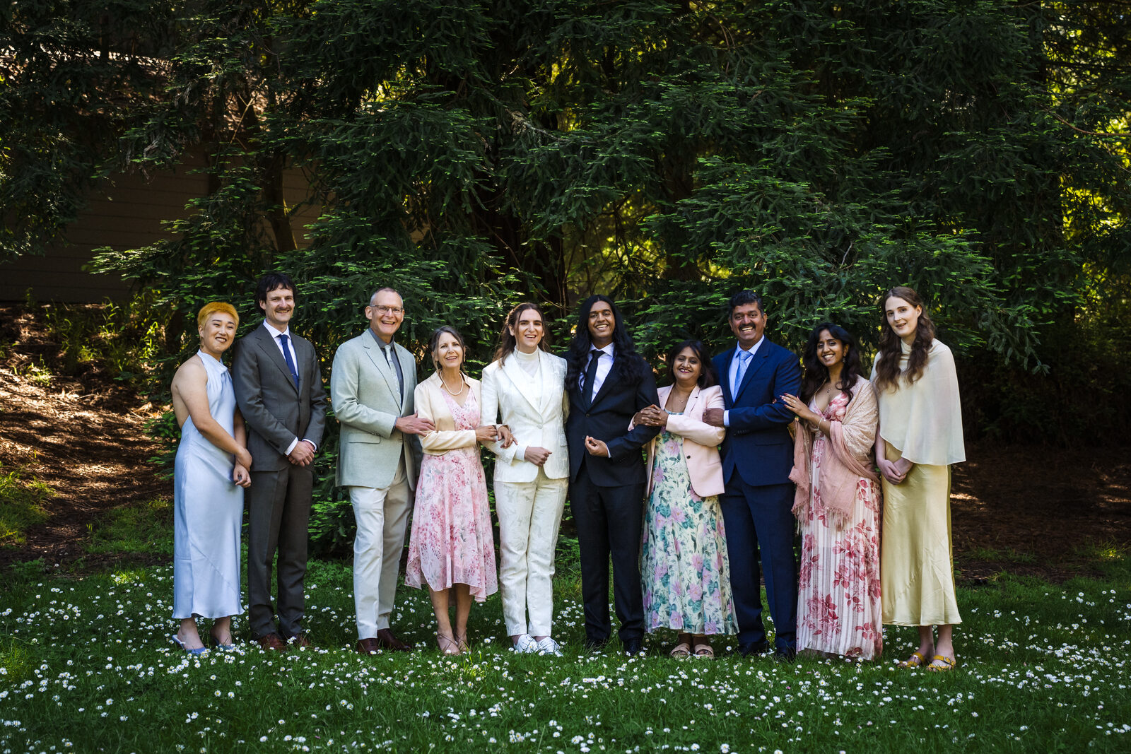 Family gathered beneath the trees